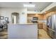 Spacious kitchen featuring stainless steel appliances, and an eat-in island for casual dining at 25659 W Forest Grove Ave, Buckeye, AZ 85326