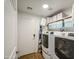 Modern laundry room equipped with a washer, dryer, shelving, and storage solutions for convenience at 25659 W Forest Grove Ave, Buckeye, AZ 85326