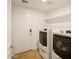 Clean laundry room with modern washer and dryer units and practical shelving at 25659 W Forest Grove Ave, Buckeye, AZ 85326