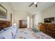 Relaxing main bedroom featuring wooden floors, a ceiling fan, and access to a private bathroom at 25659 W Forest Grove Ave, Buckeye, AZ 85326