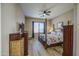 Comfortable main bedroom with wooden floors, natural light, ceiling fan, and ample closet space at 25659 W Forest Grove Ave, Buckeye, AZ 85326