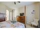 Stylish main bedroom boasts wood floors, ceiling fan, and access to the ensuite bathroom at 25659 W Forest Grove Ave, Buckeye, AZ 85326