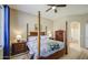 Spacious main bedroom with a four-poster bed, wooden floors, and ensuite bathroom access at 25659 W Forest Grove Ave, Buckeye, AZ 85326