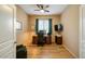 Cozy office space with a wood desk, comfortable chair, and natural light at 25659 W Forest Grove Ave, Buckeye, AZ 85326