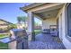 Covered patio showcasing brick pavers, stainless steel barbecue, and comfortable seating area at 25659 W Forest Grove Ave, Buckeye, AZ 85326