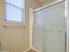 Enclosed shower with decorative frosted glass doors and chrome hardware offers a modern and private bathing space at 25659 W Forest Grove Ave, Buckeye, AZ 85326