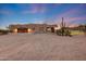 Expansive desert property featuring a putting green, outdoor lighting, and unique architecture at 28758 N Ashbrook Ln, San Tan Valley, AZ 85144