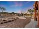 This property includes a luxurious outdoor living space with a pool, fire pit, desert landscaping, and putting green at 28758 N Ashbrook Ln, San Tan Valley, AZ 85144