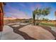 This home boasts a picturesque backyard with a waterfall pool, putting green, and desert landscaping, perfect for relaxation at 28758 N Ashbrook Ln, San Tan Valley, AZ 85144