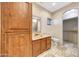 Bathroom featuring a wooden vanity, decorative mirror, toilet, and tile flooring at 28758 N Ashbrook Ln, San Tan Valley, AZ 85144