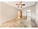 Bedroom featuring tiled flooring and access to closet and bathroom at 28758 N Ashbrook Ln, San Tan Valley, AZ 85144
