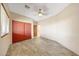 Bedroom featuring a ceiling fan, closet with double doors, light walls, and wood-look flooring at 28758 N Ashbrook Ln, San Tan Valley, AZ 85144