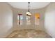 Charming breakfast nook offers views and a decorative light fixture above travertine tile flooring at 28758 N Ashbrook Ln, San Tan Valley, AZ 85144