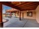 The home includes a spacious covered patio with ceiling fans and views of the pool and putting green, ideal for outdoor living at 28758 N Ashbrook Ln, San Tan Valley, AZ 85144