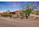 Desert home featuring a spacious driveway surrounded by native landscaping under a gorgeous twilight sky at 28758 N Ashbrook Ln, San Tan Valley, AZ 85144