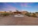 Inviting desert home with a circular drive, mature landscaping, and southwestern architecture at 28758 N Ashbrook Ln, San Tan Valley, AZ 85144
