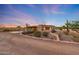Desert home featuring southwestern architecture, circular drive, and mature landscaping at 28758 N Ashbrook Ln, San Tan Valley, AZ 85144