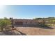 Custom home featuring a three-car garage, covered outdoor space, desert landscaping, and scenic mountain views at 28758 N Ashbrook Ln, San Tan Valley, AZ 85144