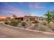 Desert home featuring a spacious driveway surrounded by native landscaping under a gorgeous twilight sky at 28758 N Ashbrook Ln, San Tan Valley, AZ 85144