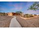 Beautiful Southwestern style home with desert landscaping and stone accented flower beds at 28758 N Ashbrook Ln, San Tan Valley, AZ 85144