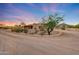 Desert home featuring a spacious driveway surrounded by native landscaping under a gorgeous twilight sky at 28758 N Ashbrook Ln, San Tan Valley, AZ 85144