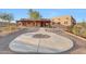 Southwest home features a circular driveway, desert landscaping, and a covered porch at 28758 N Ashbrook Ln, San Tan Valley, AZ 85144