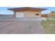 A detached garage and shop with a roll up door at 28758 N Ashbrook Ln, San Tan Valley, AZ 85144