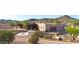 Custom home featuring desert landscaping, a concrete circular driveway, and covered patio at 28758 N Ashbrook Ln, San Tan Valley, AZ 85144
