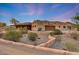 Desert home featuring a spacious driveway surrounded by native landscaping under a gorgeous twilight sky at 28758 N Ashbrook Ln, San Tan Valley, AZ 85144