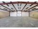 Large, empty garage with metal roof and shelving at 28758 N Ashbrook Ln, San Tan Valley, AZ 85144