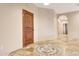 Hallway with arched entry and decorative tiled floor design at 28758 N Ashbrook Ln, San Tan Valley, AZ 85144
