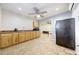 Kitchen featuring wood cabinets, a refrigerator, and a ceiling fan at 28758 N Ashbrook Ln, San Tan Valley, AZ 85144