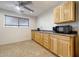 Kitchen with cabinets, microwave, and sink near the window at 28758 N Ashbrook Ln, San Tan Valley, AZ 85144