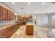 Gourmet kitchen with wood cabinets, granite countertops, an island, and stainless appliances at 28758 N Ashbrook Ln, San Tan Valley, AZ 85144