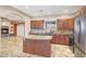 Spacious kitchen features granite countertops, stainless appliances, and a large island at 28758 N Ashbrook Ln, San Tan Valley, AZ 85144