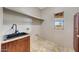 Practical laundry room including a sink, granite countertops, and a view at 28758 N Ashbrook Ln, San Tan Valley, AZ 85144