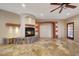 Living room featuring travertine floors, fireplace, and open shelving at 28758 N Ashbrook Ln, San Tan Valley, AZ 85144
