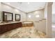 Bathroom featuring dual vanities, a jacuzzi tub, recessed lighting, and travertine tile at 28758 N Ashbrook Ln, San Tan Valley, AZ 85144