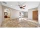 Spacious main bedroom featuring travertine floors, ceiling fan, and ensuite bathroom with jacuzzi at 28758 N Ashbrook Ln, San Tan Valley, AZ 85144