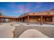 Expansive covered patio with exposed beam ceiling and ceiling fans looks out to the landscaped backyard at 28758 N Ashbrook Ln, San Tan Valley, AZ 85144