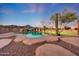 Backyard showcases a lagoon-style pool, desert landscaping, and a cactus at twilight at 28758 N Ashbrook Ln, San Tan Valley, AZ 85144