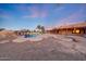 Backyard pool area with custom rock features, desert landscape, and the house exterior at 28758 N Ashbrook Ln, San Tan Valley, AZ 85144
