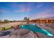 Gorgeous desert home showcasing a large inground pool and surrounding rock and desert landscape at 28758 N Ashbrook Ln, San Tan Valley, AZ 85144