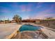 Beautiful backyard pool features stone border, water fall, and desert landscaping at 28758 N Ashbrook Ln, San Tan Valley, AZ 85144