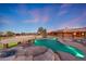 Gorgeous desert home showcasing a large inground pool and surrounding rock and desert landscape at 28758 N Ashbrook Ln, San Tan Valley, AZ 85144