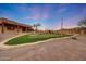 Custom putting green features artificial turf and sand trap for practice, with desert landscaping and covered patio visible at 28758 N Ashbrook Ln, San Tan Valley, AZ 85144