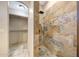 Shower featuring stone tile walls, rainfall shower head, and glass divider at 28758 N Ashbrook Ln, San Tan Valley, AZ 85144