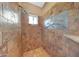 Walk-in shower adorned with decorative tile and a built-in shelf at 28758 N Ashbrook Ln, San Tan Valley, AZ 85144