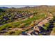 Aerial view of a golf course winding through a residential community surrounded by desert landscape and mountains at 3055 N Red Mtn # 122, Mesa, AZ 85207