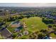 Aerial view of neighborhood amenities including a playground and a large open green space at 3055 N Red Mtn # 122, Mesa, AZ 85207